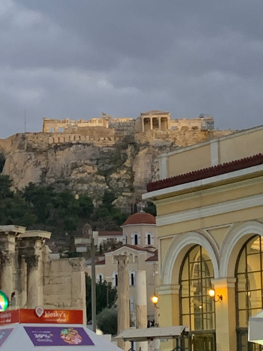 View of the Acropolis in Athens, Greece above the city at dusk.