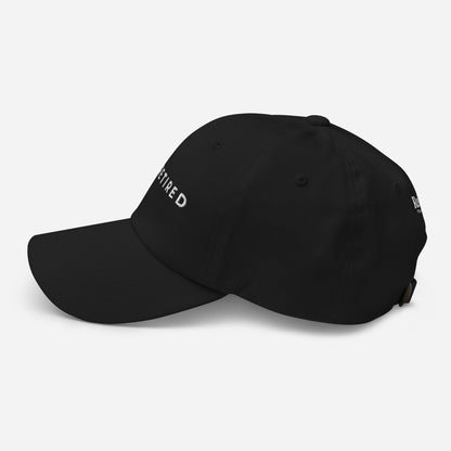 Black embroidered I’m Retired travel dad hat from Retired Traveler (Left side)
