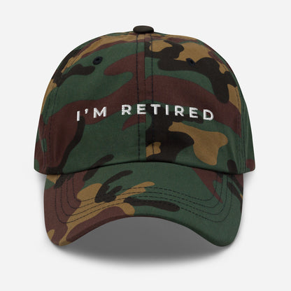 Camo embroidered I’m Retired travel dad hat from Retired Traveler (Front)