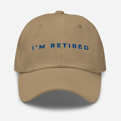 Khaki I’m Retired travel dad hat with royal blue embroidery from Retired Traveler (Front)
