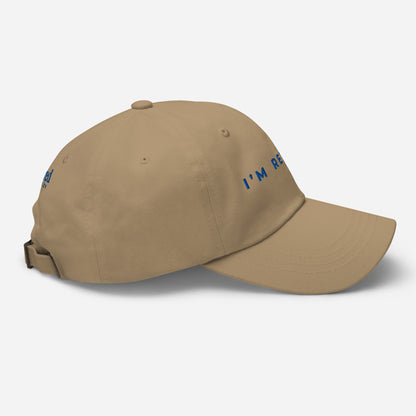 Khaki I’m Retired travel dad hat with royal blue embroidery from Retired Traveler (Right)