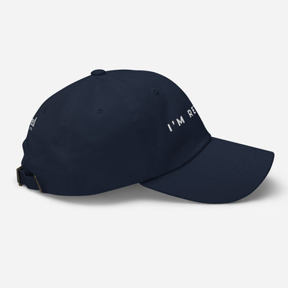 Navy embroidered I’m Retired travel dad hat from Retired Traveler (Right)